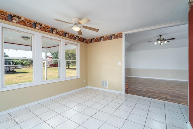 unfurnished room featuring ceiling fan and light tile patterned floors