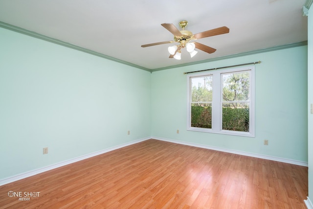 empty room with ornamental molding, ceiling fan, and light hardwood / wood-style flooring