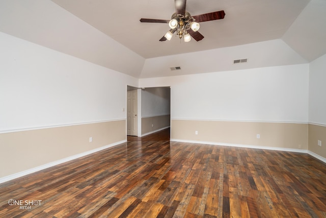 spare room with vaulted ceiling, dark hardwood / wood-style floors, and ceiling fan