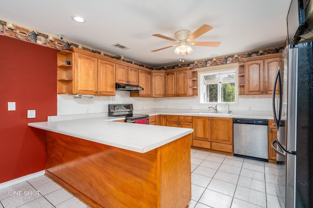 kitchen with tasteful backsplash, stainless steel appliances, kitchen peninsula, and light tile patterned floors