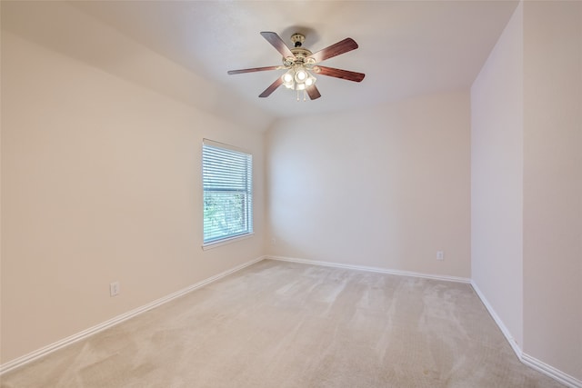 unfurnished room with lofted ceiling, ceiling fan, and light carpet