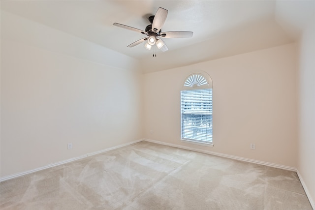 spare room featuring light carpet and ceiling fan