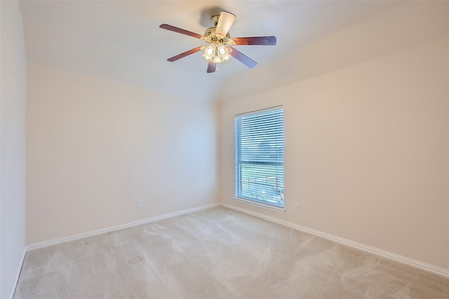 carpeted spare room with ceiling fan