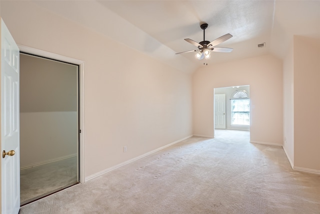 carpeted empty room featuring lofted ceiling and ceiling fan