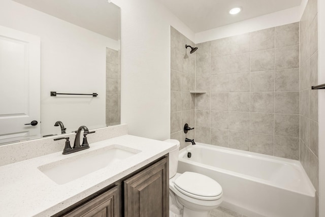 full bathroom featuring vanity, toilet, and tiled shower / bath