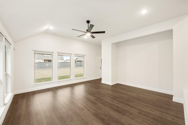 empty room with dark hardwood / wood-style floors, ceiling fan, and lofted ceiling