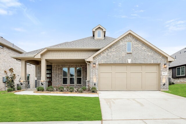 view of front facade featuring a porch, a garage, and a front lawn