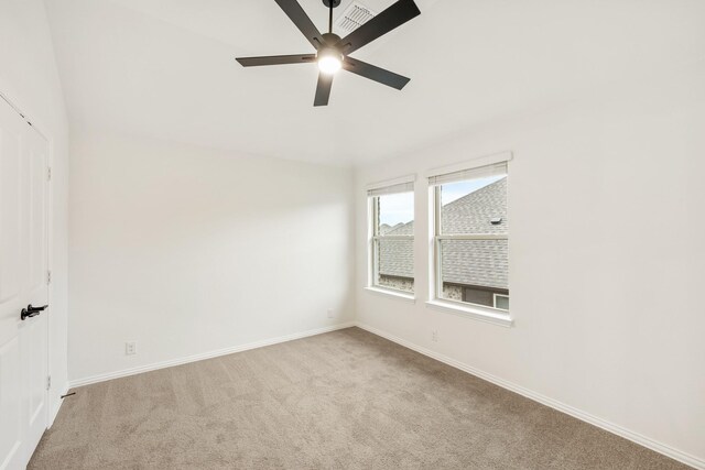 spare room featuring ceiling fan and light colored carpet