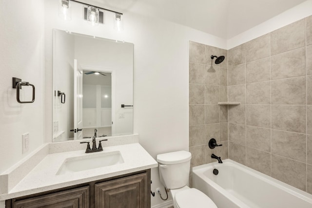 full bathroom with vanity, tiled shower / bath, and toilet