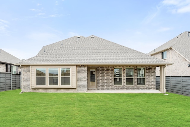 back of house with a patio and a lawn