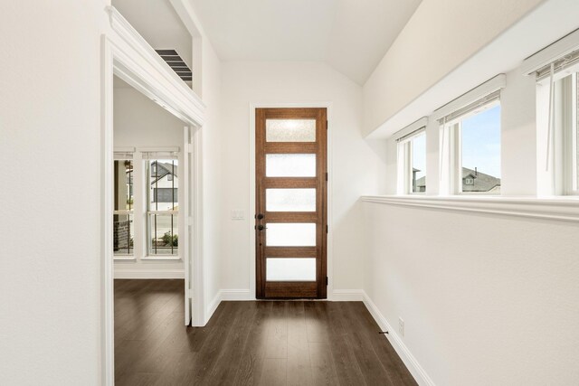 entryway with dark hardwood / wood-style flooring and lofted ceiling