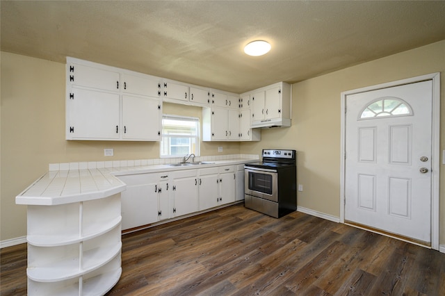 kitchen with sink, dark hardwood / wood-style flooring, stainless steel electric stove, and tile countertops