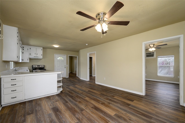 kitchen featuring white cabinets, stainless steel electric range, ceiling fan, dark hardwood / wood-style floors, and sink