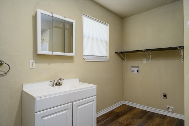 laundry area with sink, hookup for a washing machine, hookup for an electric dryer, and dark wood-type flooring