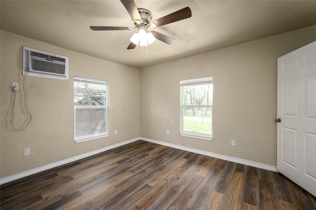 unfurnished room featuring dark hardwood / wood-style flooring, a wealth of natural light, and ceiling fan