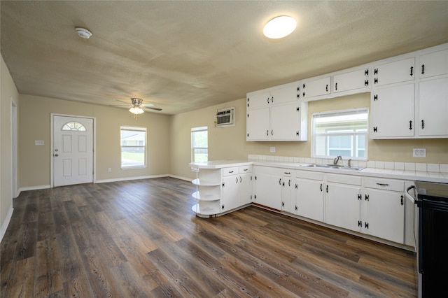 kitchen with white cabinets, sink, dark hardwood / wood-style floors, tile counters, and ceiling fan