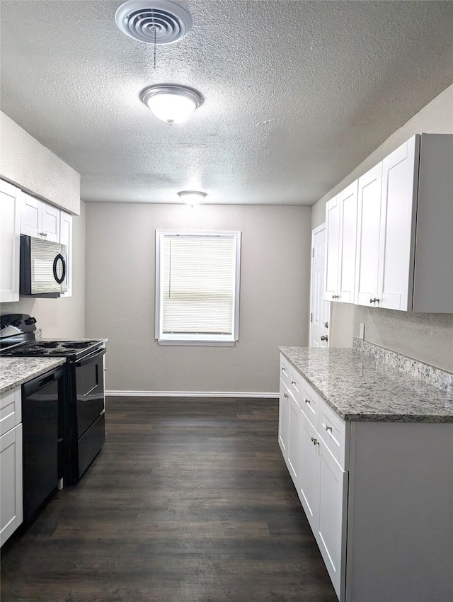 kitchen featuring light stone counters, white cabinets, and black appliances