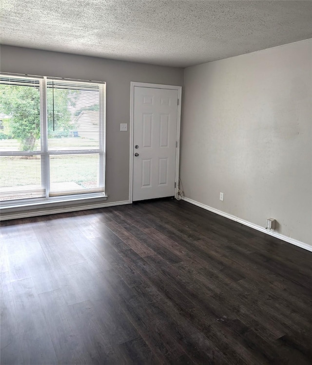 foyer with a textured ceiling and dark hardwood / wood-style floors