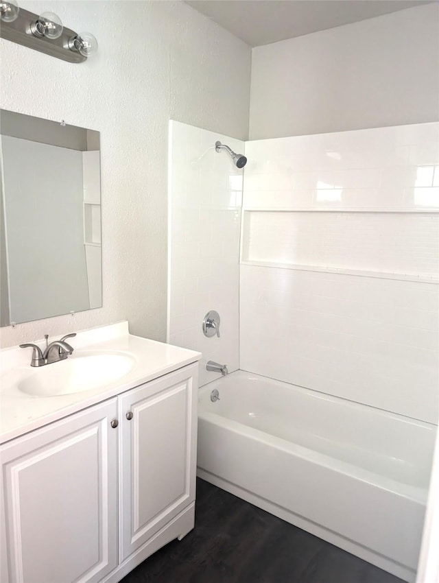 bathroom with vanity, wood-type flooring, and shower / washtub combination