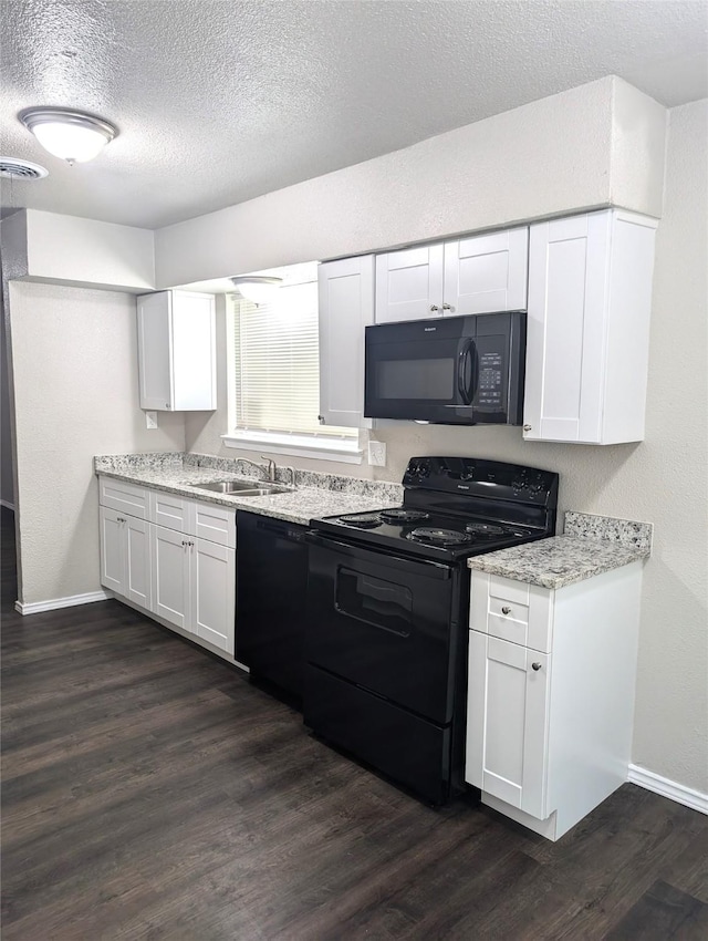 kitchen featuring dark hardwood / wood-style flooring, a textured ceiling, black appliances, white cabinets, and sink