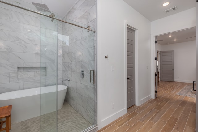 bathroom with shower with separate bathtub