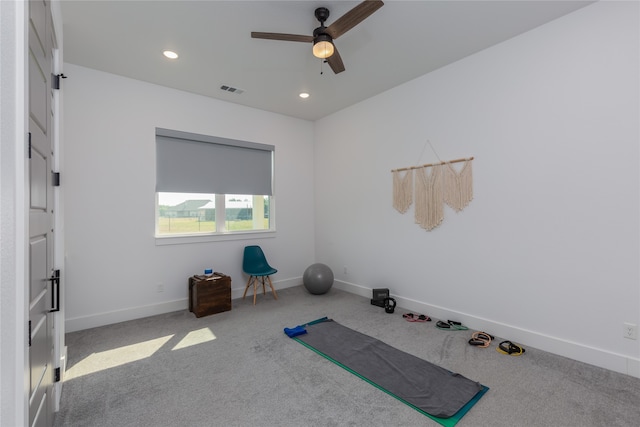 exercise room with carpet floors and ceiling fan