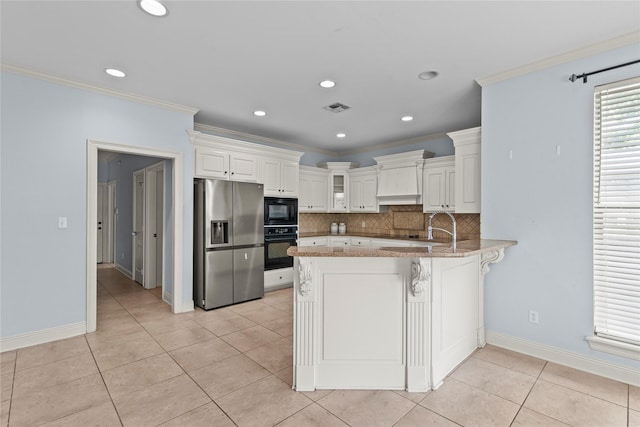 kitchen with ornamental molding, black appliances, kitchen peninsula, and white cabinets