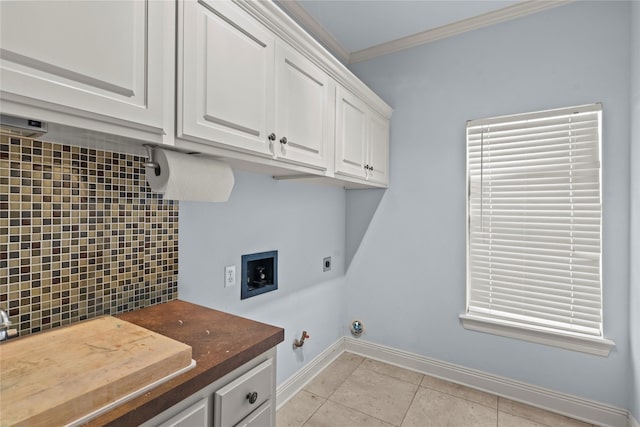 laundry room with gas dryer hookup, cabinets, light tile patterned floors, crown molding, and hookup for an electric dryer