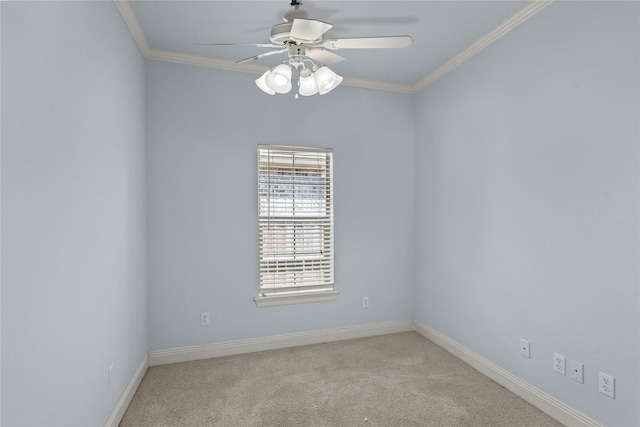 carpeted spare room featuring crown molding and ceiling fan