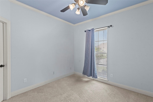 spare room featuring ornamental molding, carpet floors, and ceiling fan