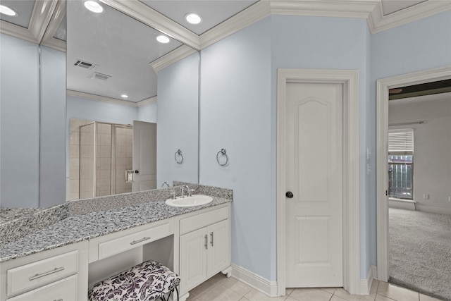bathroom featuring tile patterned flooring, crown molding, vanity, and walk in shower