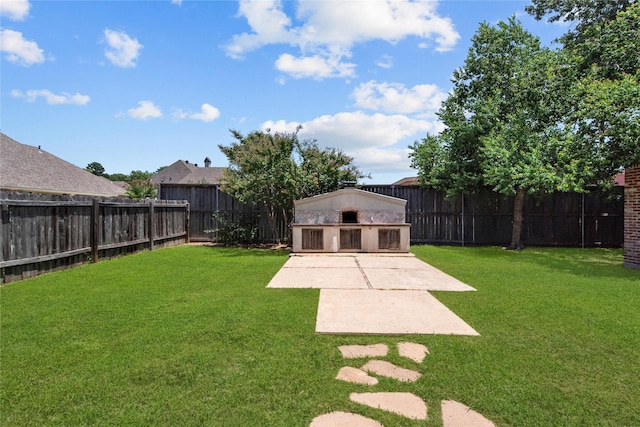 view of yard featuring an outbuilding and a patio area