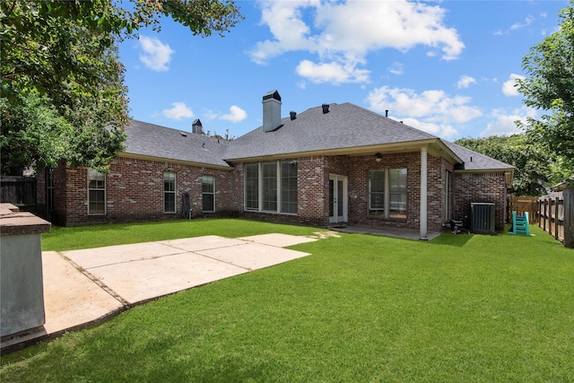 back of house with central AC unit, a lawn, and a patio