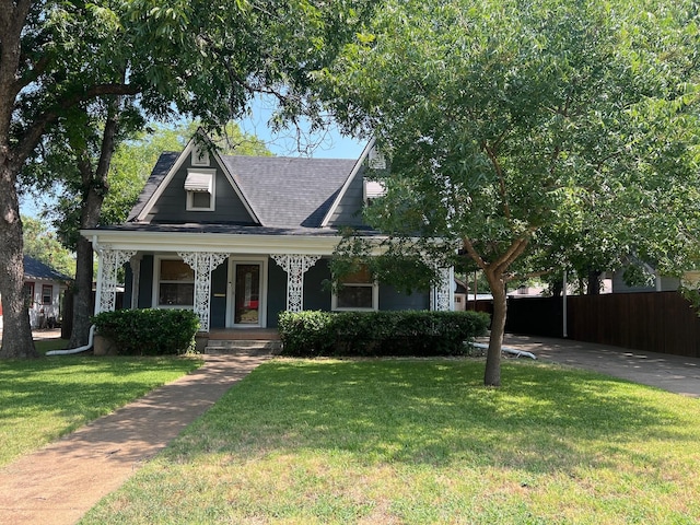 view of front of house with a front yard and covered porch