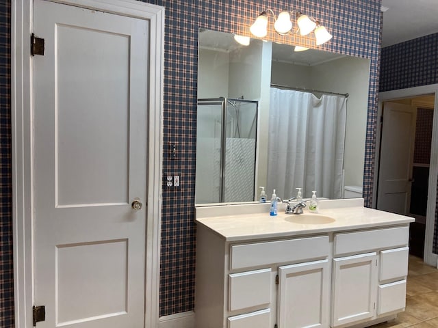 bathroom featuring curtained shower, vanity, tile patterned floors, and crown molding