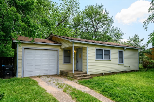 ranch-style house with a garage and a front lawn