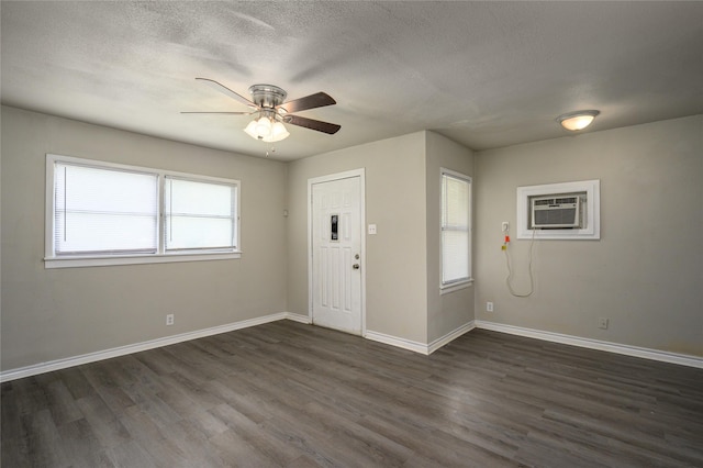 entryway featuring ceiling fan, dark hardwood / wood-style floors, and a textured ceiling