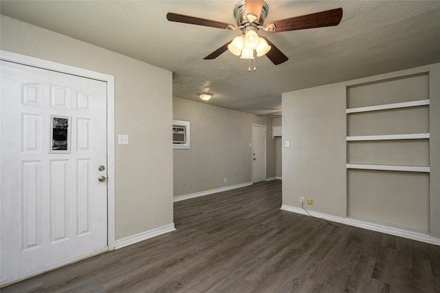 foyer entrance with dark wood-type flooring, a wall mounted AC, and ceiling fan