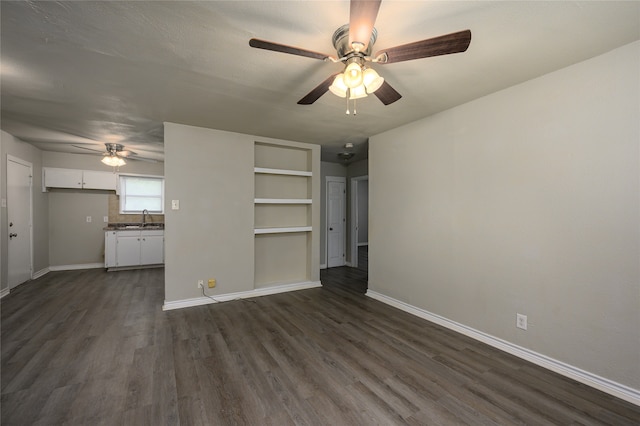 unfurnished living room featuring dark hardwood / wood-style flooring, sink, and ceiling fan