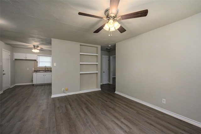 unfurnished bedroom with sink, dark wood-type flooring, and ceiling fan