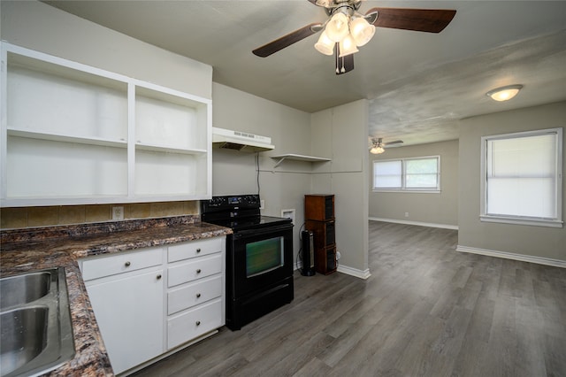 kitchen featuring dark hardwood / wood-style floors, ceiling fan, white cabinets, and black range with electric cooktop