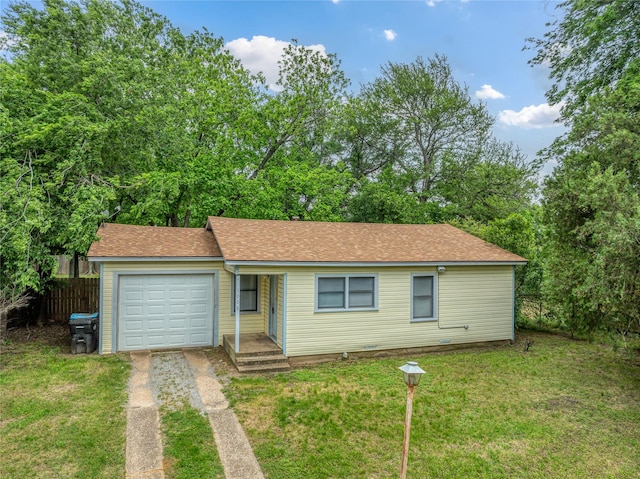 single story home featuring a garage and a front lawn