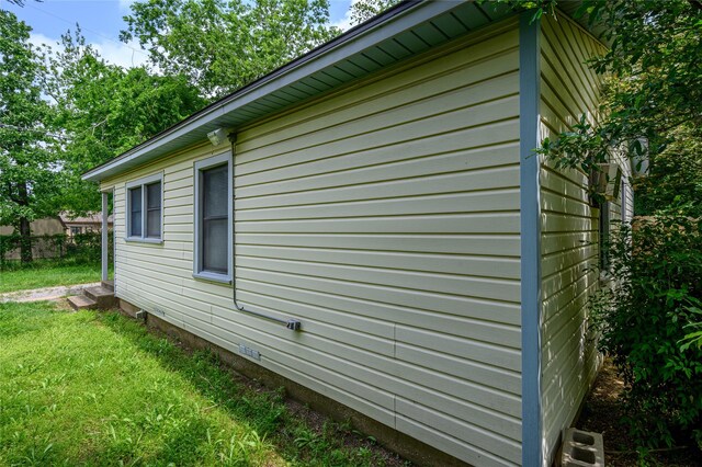 view of side of property with a yard