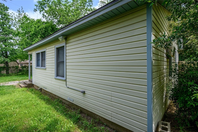 view of property exterior with a lawn