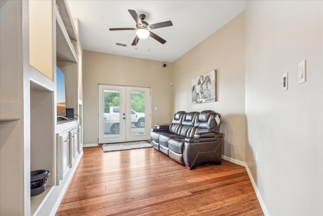 sitting room featuring light wood-type flooring, ceiling fan, and french doors