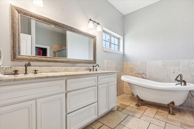 bathroom featuring tile walls, dual bowl vanity, and tile patterned floors