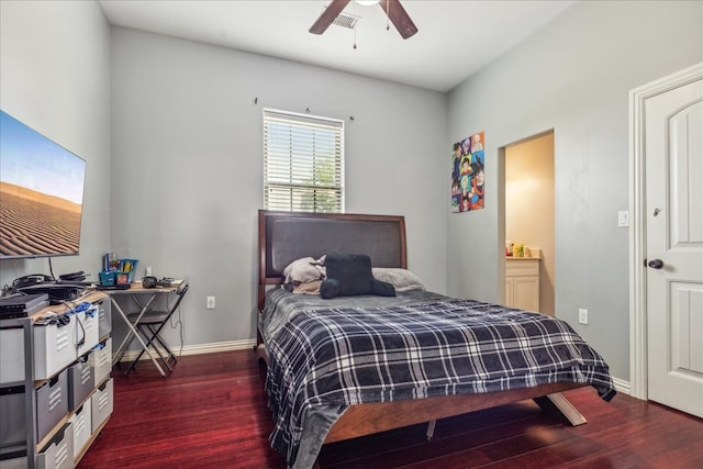 bedroom featuring dark wood-type flooring, ensuite bath, and ceiling fan