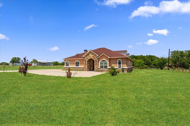 mediterranean / spanish-style house featuring a front yard