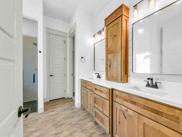 bathroom featuring walk in shower and vanity