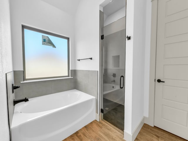 bathroom featuring independent shower and bath and hardwood / wood-style flooring